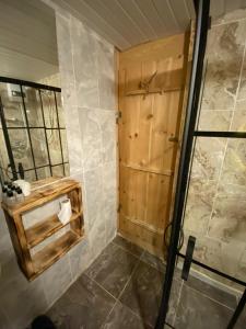 a bathroom with a shower and a toilet paper dispenser at Moromu Bungalows in Çamlıhemşin