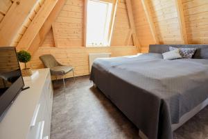 a bedroom with a bed in a wooden cabin at MP23 - Strandvogt 3 Komfort in Dorum Neufeld