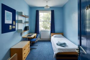 a room with a bed and a desk and a window at Gower Street Houses, Fitzrovia, London in London