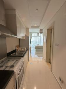 a kitchen with a sink and a stove top oven at Tranquil Studio in Damac Hills in Dubai