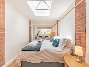 a bedroom with a large bed with a skylight at Cyrabel in Boultham