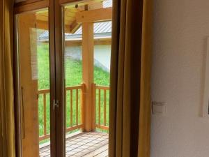 an open door to a porch with a deck at Warm Chalet in Oz with Ski Storage Balcony Terrace Heating in Oz