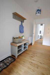 a room with white walls and a wooden floor at Walters Neuk Anstruther- luxury coastal home in Anstruther