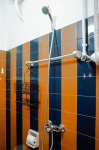 a shower in a bathroom with colorful tiles at Studio 70 in Argos