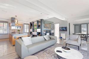 a living room with a couch and a table at Harbour facing Penthouse in Cape Town