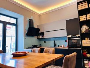 a kitchen with a wooden table and a dining room at Apartment for special getaway Rose with FREE parking in Pula