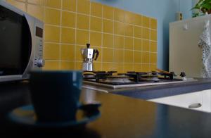 a kitchen with a stove with a coffee pot on it at Casa Del Monte in Naples