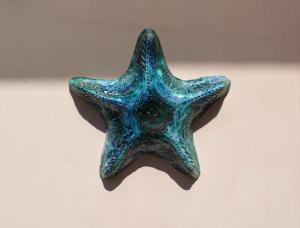 a blue star shaped object hanging on a wall at Casa Del Monte in Naples