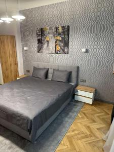 ein Schlafzimmer mit einem großen Bett und Plakaten an der Wand in der Unterkunft Lux apartments Top center in Sofia