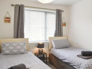 a bedroom with two beds and a window at Harbour View - Uk44164 in Bridlington