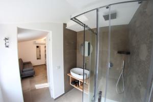 a bathroom with a shower with a glass door at Dalì al mare in Cefalù