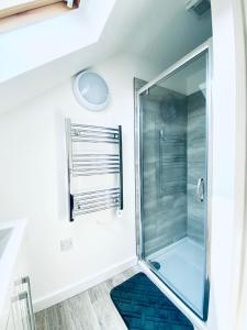 a shower with a glass door in a bathroom at HU-Thirteen Loft Duplex Studio- Sleeps 2 in Hull
