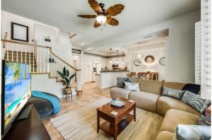 a living room with a couch and a tv at Kulalani At Mauna Lani 804 in Waikoloa