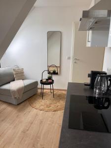 a living room with a couch and a table at FarawayHomes Studio Klagenfurt #2 in Klagenfurt