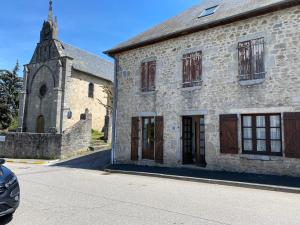 an old stone building with a small church at Confortable et agréable T1 n•1 in Ussel