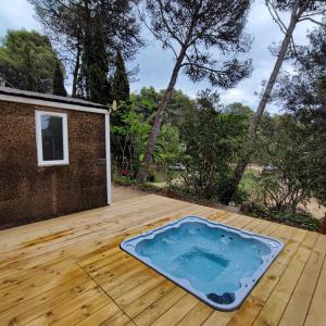 a hot tub sitting on a wooden deck at Camping Santa Elena in Lloret de Mar