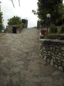 a stone walkway with a stone wall and a street light at VILLA ANNA 