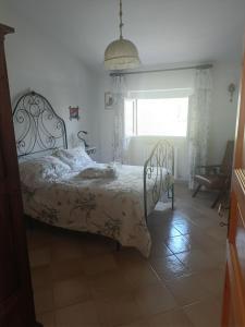 a bedroom with a bed and a window and a chair at VILLA ANNA 