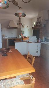 a kitchen with a wooden table and a counter top at VILLA ANNA 