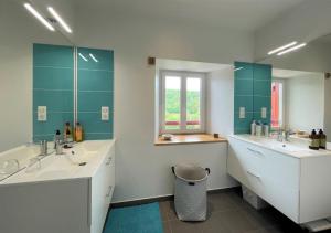 a large bathroom with two sinks and a window at Eiherabidia in Orsanco +35 photos