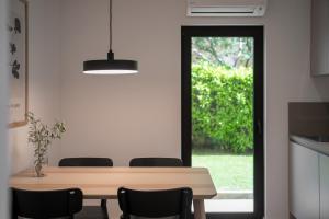 a dining room with a table and chairs and a window at Upper Sea View Apartments in Vrsar