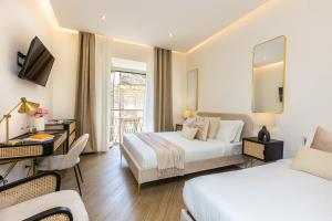 a hotel room with two beds and a television at Colosseum Boutique Apartment in Rome