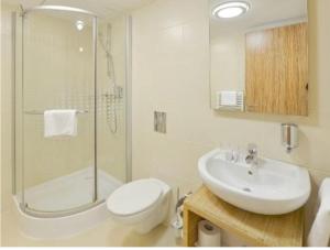 a bathroom with a sink and a toilet and a shower at Velence Resort & Spa in Velence