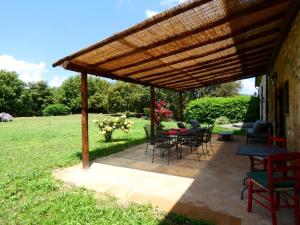 a patio with a wooden pergola and tables and chairs at SCAPPO IN UMBRIA, Casale Monti in Montoro +43 photos