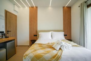 Postel nebo postele na pokoji v ubytování Omnia Deluxe Rooms
