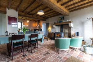 a dining room with a table and a fireplace at Les Chaumes en Morvan in Préporché