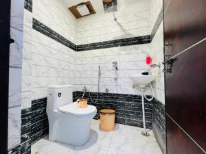 uma casa de banho com um WC e um lavatório em The Bella Guesthouse em Varanasi