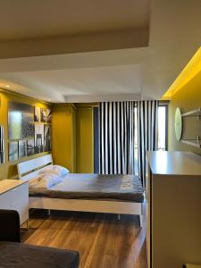 a bedroom with a bed and a desk at Deluxe Beach Residence in Samsun