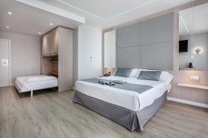 Hospedium Hotel Abril في سان خوان دي أليكانتي: غرفة نوم كبيرة مع سرير كبير وتلفزيون