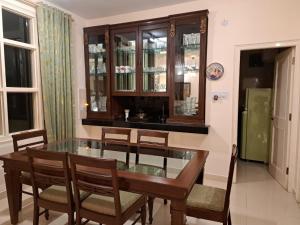 a dining room with a glass table and chairs at BluSalzz Villas - The Pine Tree, Dalhousie - Himachal Pradesh in Dalhousie
