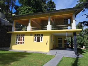 a yellow house with the front of it at BluSalzz Villas - The Pine Tree, Dalhousie - Himachal Pradesh in Dalhousie