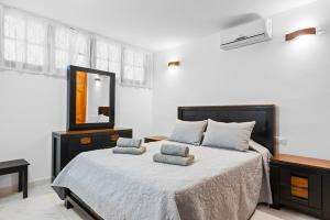 a bedroom with a large bed and a mirror at Neptuno Pool and beach private access in Puerto de Santiago