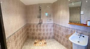 a bathroom with a bath tub and a sink at Lavender and Poppy cottages in Bebrovo +19 photos
