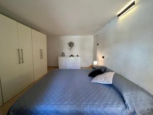 a bedroom with a large bed in a white room at Apartment Eleni in Rovinj +6 photos