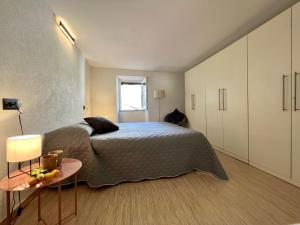 a bedroom with a bed and a table at Apartment Eleni in Rovinj