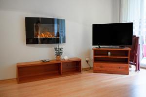 a living room with a tv and a fireplace at Grunwaldzka 104 in Pobierowo