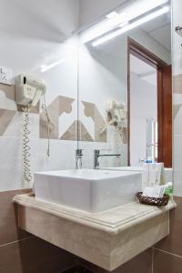 een badkamer met een witte wastafel en een spiegel bij Song Anh 1 Hotel in Ho Chi Minh-stad
