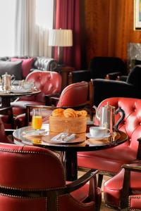 a restaurant with two tables and chairs with food on them at The Beaumont Hotel in London