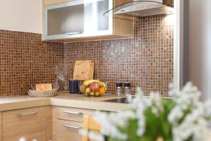 a kitchen counter with a bowl of fruit on it at Villa Orelia in Hanioti