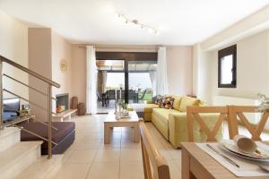 a living room with a couch and a table at Villa Orelia in Hanioti +9 photos