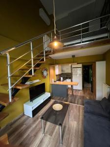 a living room with a couch and a staircase at Deluxe Beach Residence in Samsun