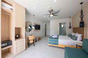 een slaapkamer met een bed, een bureau en een tafel bij Sirios Village Hotel & Bungalows - All Inclusive in Kato Daratso