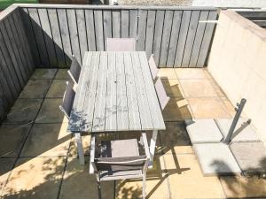 a picnic table and two chairs on a patio at Rhonas Cottage in Abergavenny