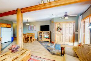 a living room with a kitchen and a dining room at Snow Leopard's Retreat in Big White