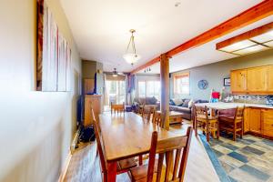 a dining room and kitchen with a table and chairs at Snow Leopard's Retreat in Big White