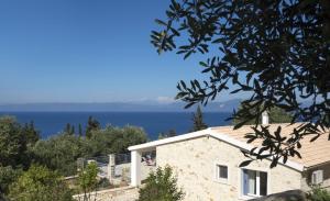 a house with a view of the ocean at Monodendri Blue in Georgoutsátika